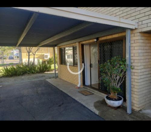 a front porch of a house with a plant at Avondale Apartment in Lismore