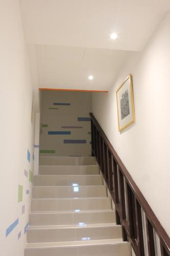 a staircase in a building with a painting on the wall at Slowlife Beach in Nai Yang Beach