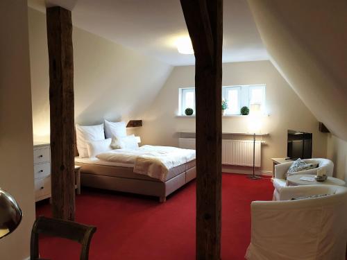 a bedroom with a bed and a red carpet at fewo1846 - Jugendstil Villa Royal in Flensburg