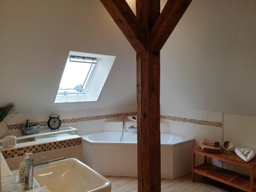 a bathroom with a tub and a sink and a window at fewo1846 - Jugendstil Villa Royal in Flensburg