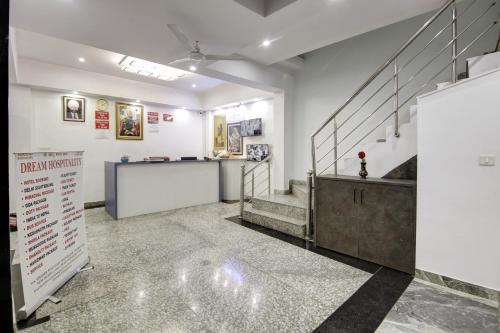 a room with stairs and a counter with a sign at Hotel S B INN Paharganj in New Delhi