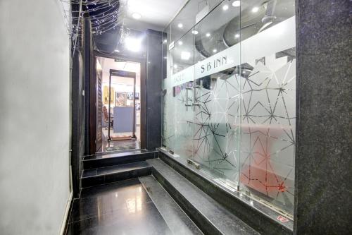 a hallway with a glass window in a building at Hotel SB Grand Inn - Paharganj in New Delhi
