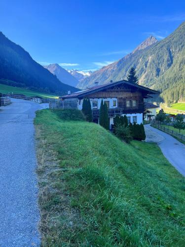 a house on a hill next to a river at Lärchenheim in Neustift im Stubaital