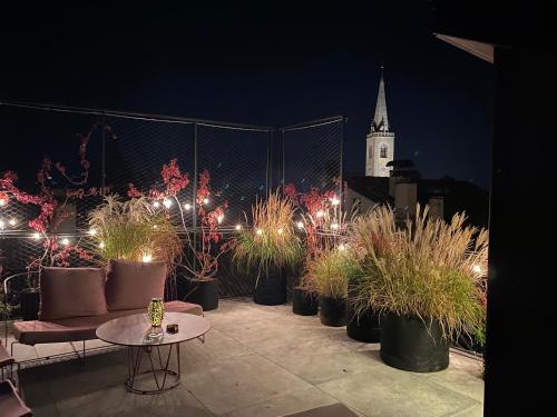 a group of potted plants on a patio at night at Goldengel Design - Suiten im historischen Ortskern von Kaltern in Caldaro