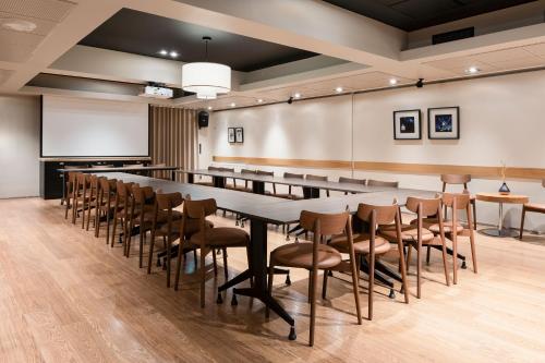 a large conference room with a long table and chairs at Original Sokos Hotel Tapiola Garden Espoo in Espoo