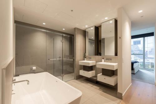 uma casa de banho com 2 lavatórios e um chuveiro em Supreme Sub-Penthouse - 3 Bedroom 2 Bathroom Melbourne CBD em Melbourne