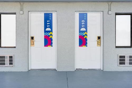 three doors on a building with signs on them at Howard Johnson by Wyndham Orlando Lake Buena Vista South in Kissimmee