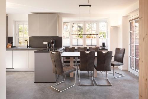 a kitchen and dining room with a table and chairs at Family&Friends in Wyk auf Föhr