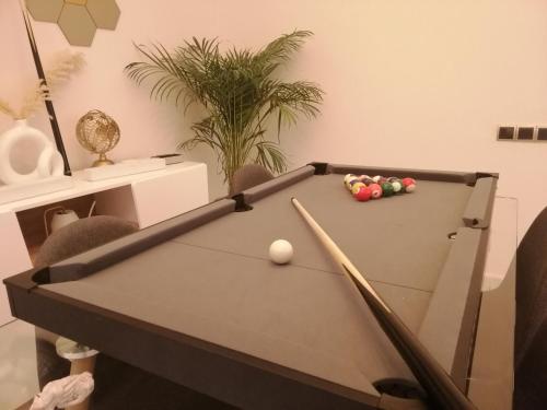 a billiard table with two balls and a cue at AeroSuite in Nouaceur