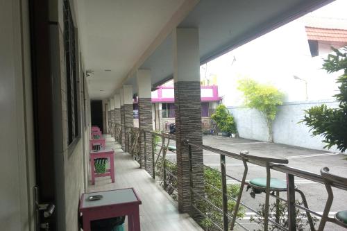 a corridor of a building with a balcony at Hotel Orchid Syariah in Tegal