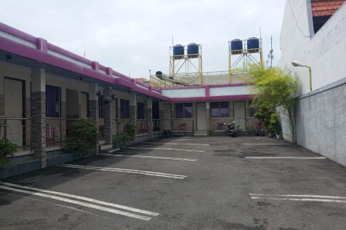 an empty parking lot in front of a building at Hotel Orchid Syariah in Tegal