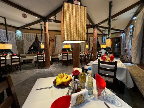 a dining room with a table with bananas on it at Family Hotel Eterno in Tsigov Chark