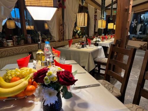 a table with fruits and vegetables in a restaurant at Family Hotel Eterno in Tsigov Chark