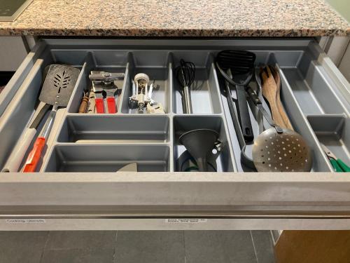 a drawer filled with kitchen utensils on a counter at Brahms 25 in Regensburg