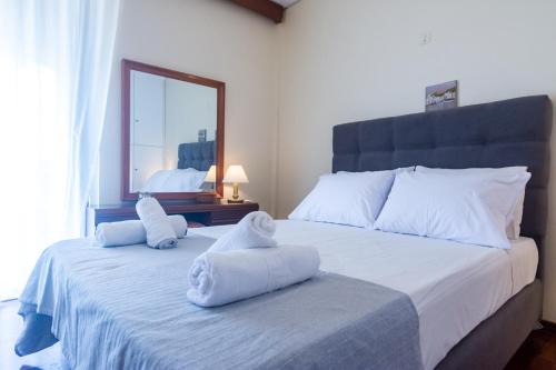 a bedroom with a large bed with towels on it at Stellas apartment in Análipsis