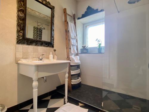 a bathroom with a sink and a shower at Gîte de charme avec piscine chauffée et WiFi - 2 chambres - FR-1-306-803 in Châteauthébaud