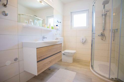 a bathroom with a sink and a shower and a toilet at Apartment in Nova Vas/Istrien 35437 in Nova Vas