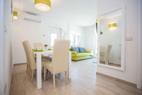 a dining room with a white table and chairs at Apartment in Nova Vas/Istrien 35437 in Nova Vas