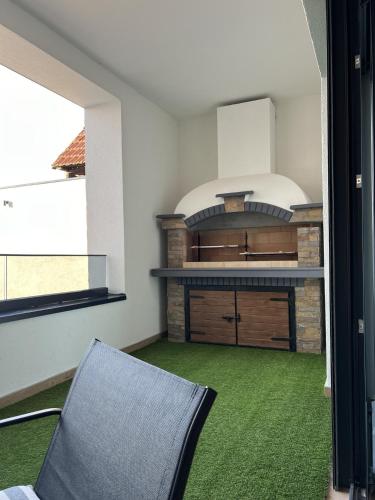 a kitchen with a stove and a chair in a room at Olimpiko in Vrdnik