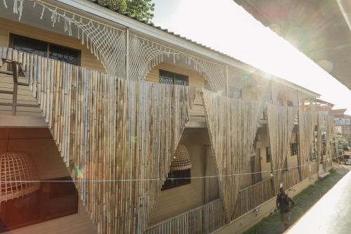 a building with a bunch of white curtains on it at U're Holitel in Haad Rin