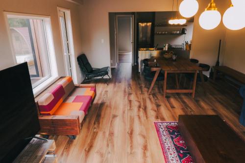 a living room with a couch and a table at LOCALINO STAY AOSHIMA in Miyazaki