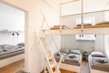 a room with two bunk beds and a staircase at Oktoberfest Oasis for up to 12 in Munich
