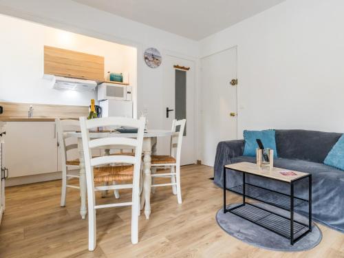a living room with a couch and a table at Studio à Mesquer: Plage à 200m, Balcon, Parking, Proche Commerces - FR-1-306-1243 in Mesquer