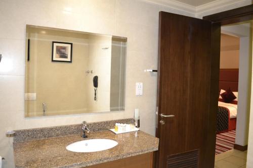 a bathroom with a sink and a mirror at Wonder Palace Hotel Qatar in Doha