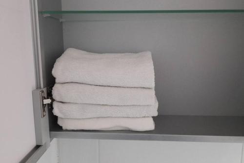 a stack of towels sitting on a shelf in a bathroom at Mong House #Mangwon-dong Mangridangil 2F Private stay in Seoul