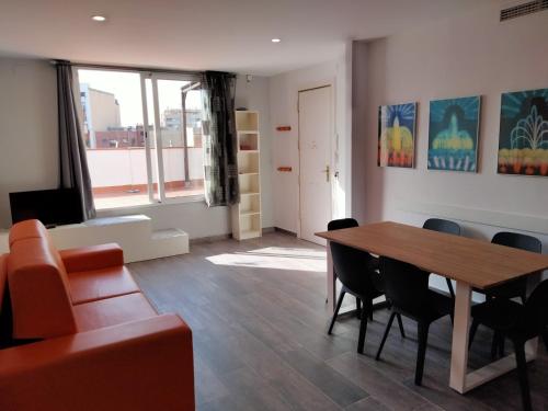 a living room with a table and a couch at Apartamentos Turísticos Tenor by Bossh! Hotels in Barcelona