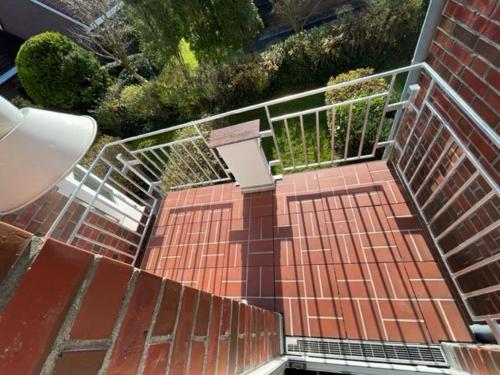 an overhead view of a brick walkway with a metal railing at Deichblick II in Harlesiel