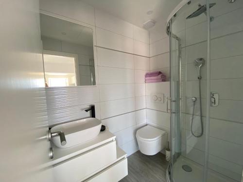 a bathroom with a toilet and a glass shower at Guest House Meri in Bol