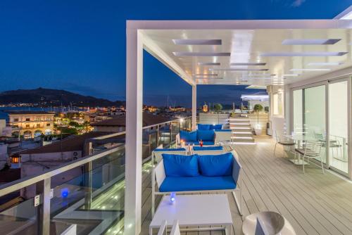 a balcony with blue couches and a view of the city at Diana Hotel in Zakynthos