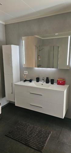 a bathroom with a white sink and a mirror at Panorama wiev in Stranda
