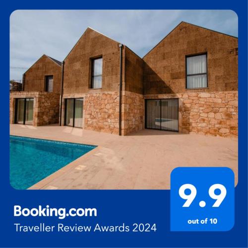a brick house with a pool in front of it at Chalês - Maria Alva in Marialva