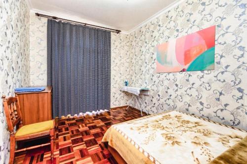 a small bedroom with a bed and a window at Azneft Royal Suite Apartment Sea View in Baku