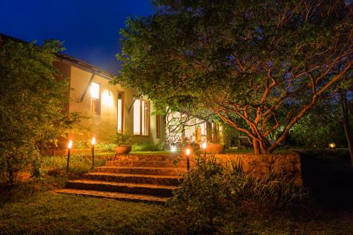 a house with lights in front of it at night at Nyne Hotels Mayur Lodge - Yala - All Inclusive in Yala
