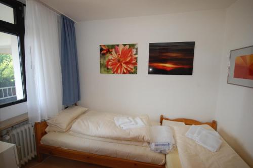 una camera con un letto e due quadri appesi al muro di HOF 203 - Berliner Hof - Seeblick a Scharbeutz