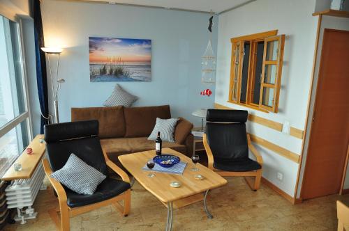 un soggiorno con divano, sedie e tavolo di RES 406 - Apartment Meeresliebe - Seeblick a Scharbeutz