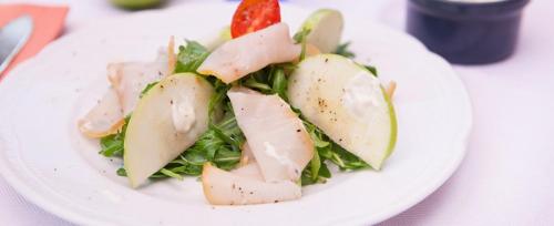 a white plate with a salad with apples on it at Hotel Valbrenta in Limena
