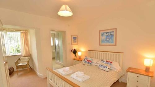 a bedroom with a bed with two pillows on it at Chymoresk - Self Catering Holiday Cottage Hayle St Ives Bay in Hayle