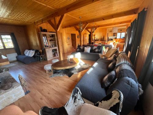 a living room with a couch and a table at Chalet l'Aigle bleu in Uvernet-Fours