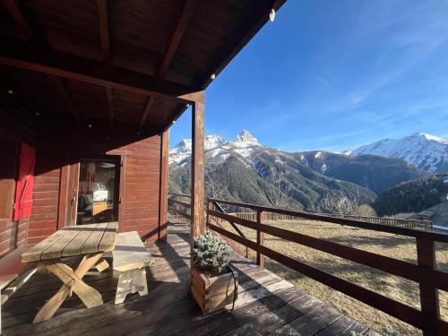 a porch of a cabin with a view of mountains at Chalet l'Aigle bleu in Uvernet-Fours