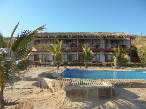 a resort with a swimming pool and a building at Balihai Bungalows in Canoas De Punta Sal