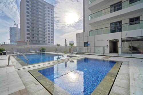 a swimming pool in the middle of a building at Stella Stays Charming 1 BDR Dubai JVC Large Terrace in Dubai