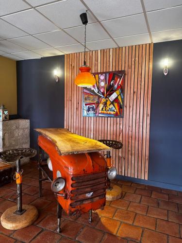 a room with a table and a painting on the wall at L'Aquitaine - Cahors Sud in LʼHospitalet