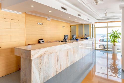 an office with a large lobby with a reception counter at Apartamentos Vibra Tropical Garden in Ibiza Town