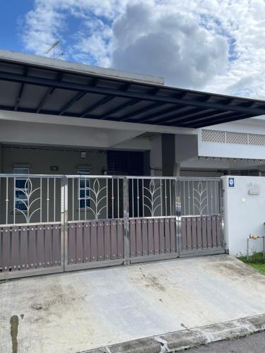 a house with a gate and a fence at C & L Home 002 in Kluang