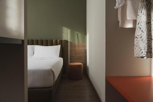 a small bedroom with a bed and a small closet at Al Ponticello in Comacchio