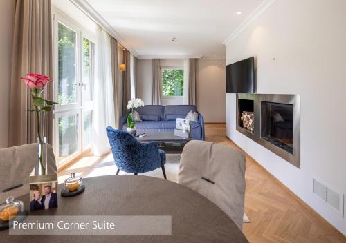 a living room with a couch and a table at Lenkerhof gourmet spa resort - Relais & Châteaux in Lenk